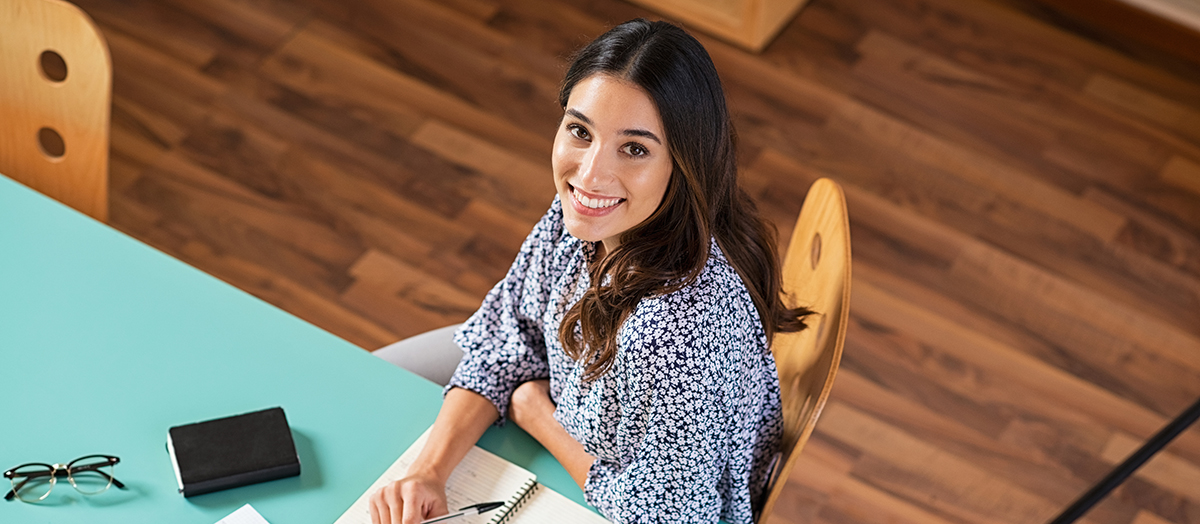 Happy young woman studying